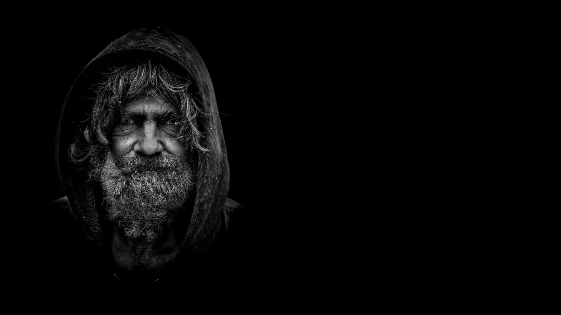 Black-and-white portrait of a man experiencing homelessness